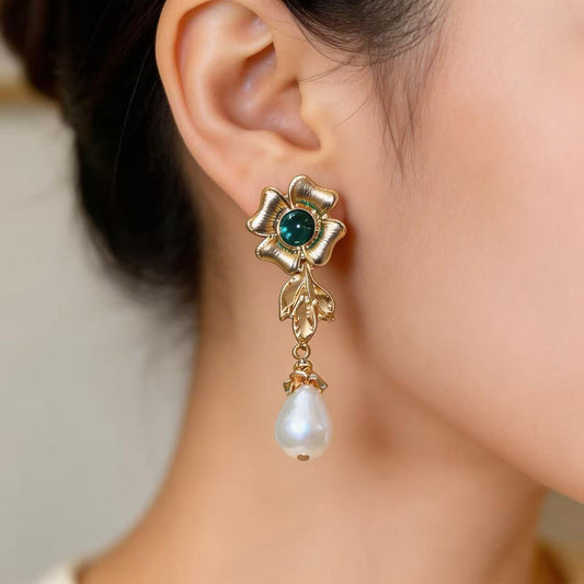 Pearl flowers illuminate your face, radiating elegance by your ears.