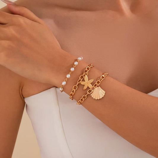 Seaside romance: starfish shell bracelet meets white dress