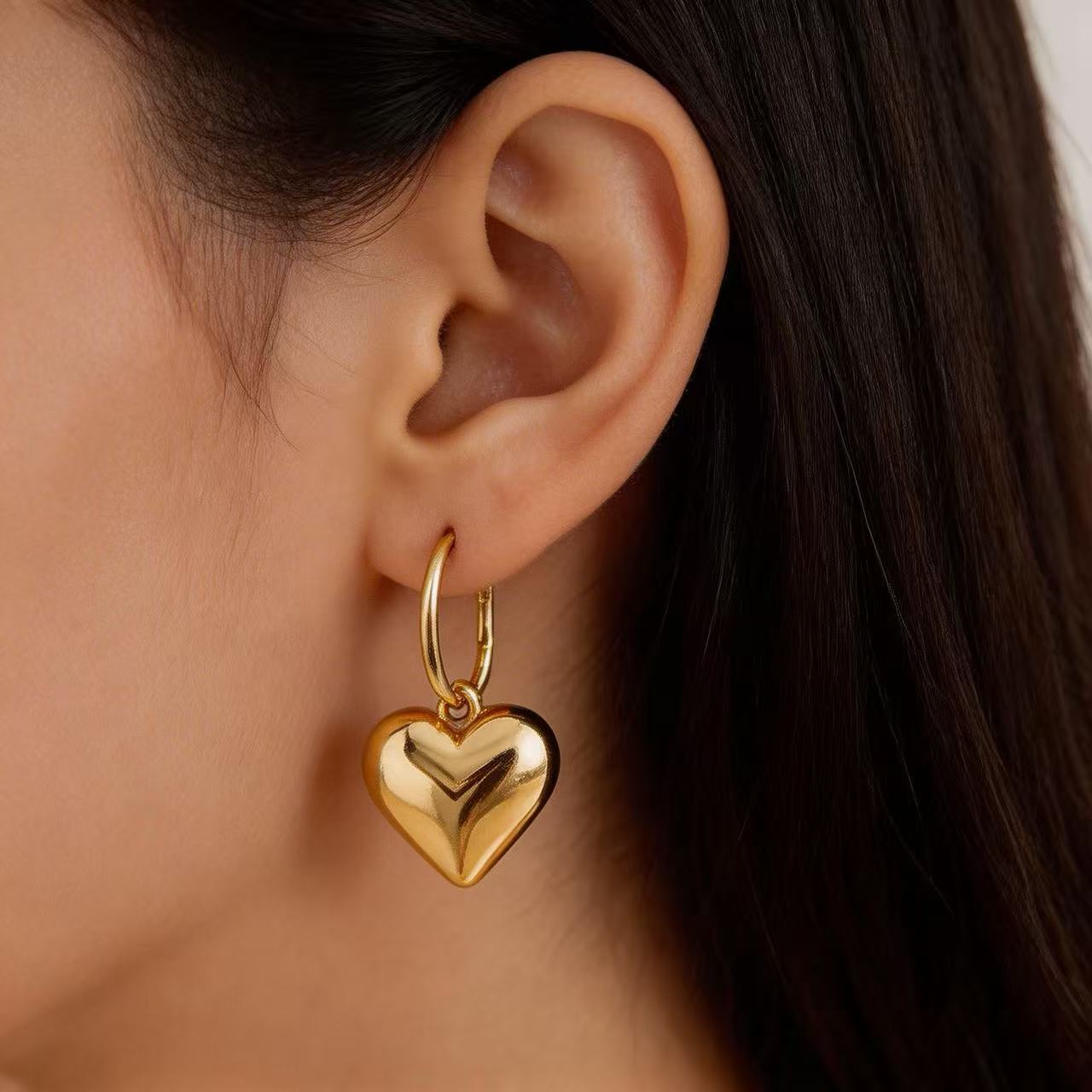 The sophisticated code of a hoodie, jeans, and heart-shaped earrings