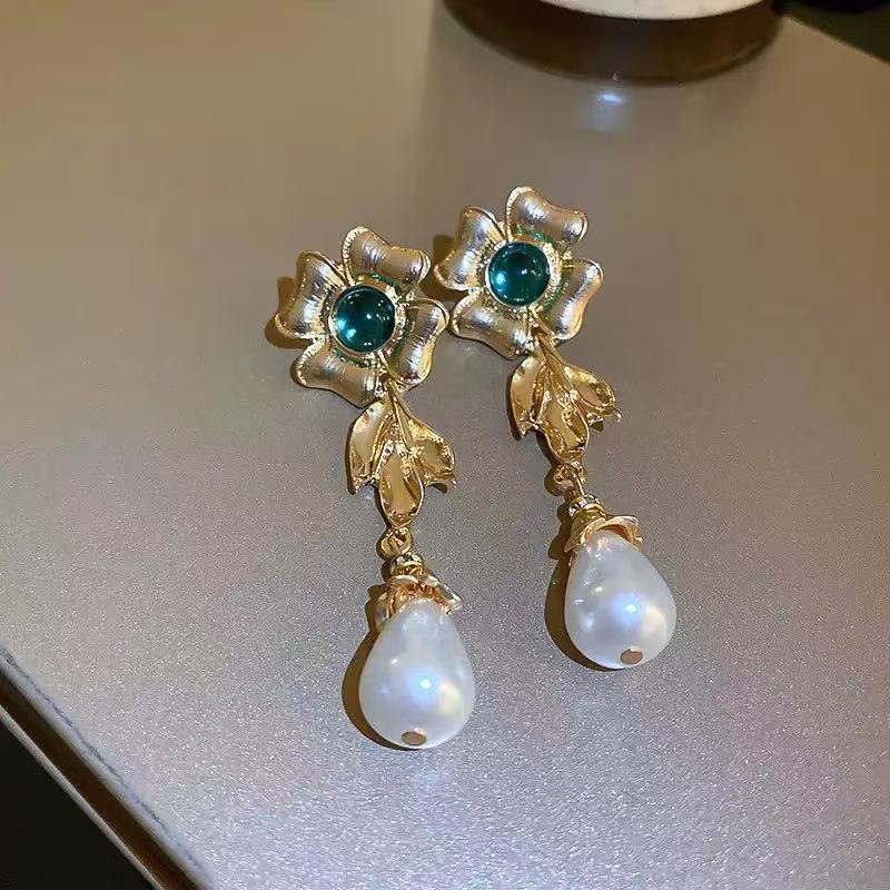 Pearl flowers illuminate your face, radiating elegance by your ears.